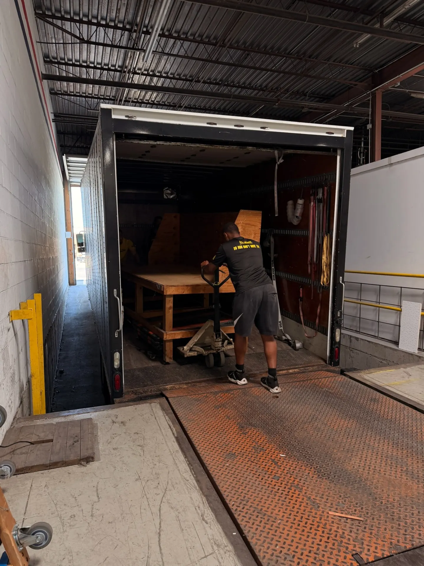 Yellow Truck Moving team loading furniture into a moving truck at a loading dock