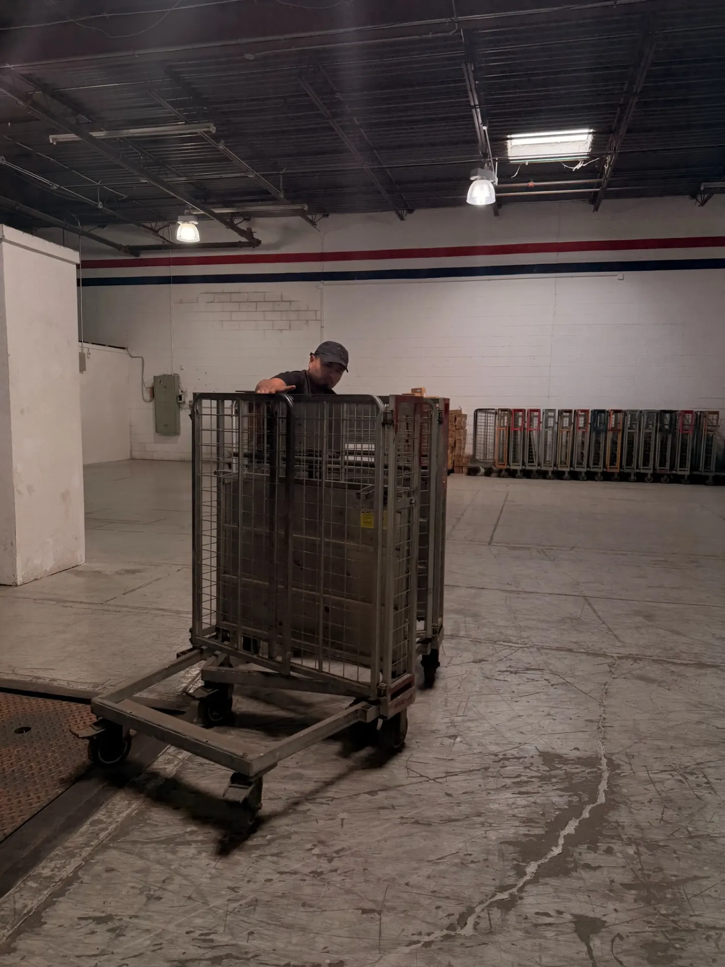 Yellow Truck Moving crew member maneuvering moving carts in a facility