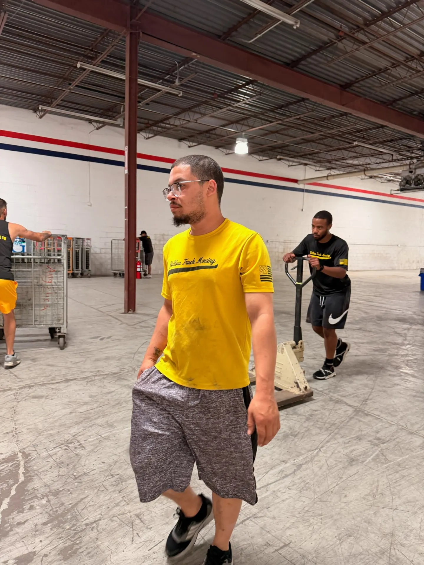 Yellow Truck Moving team member in a branded yellow shirt at a job site